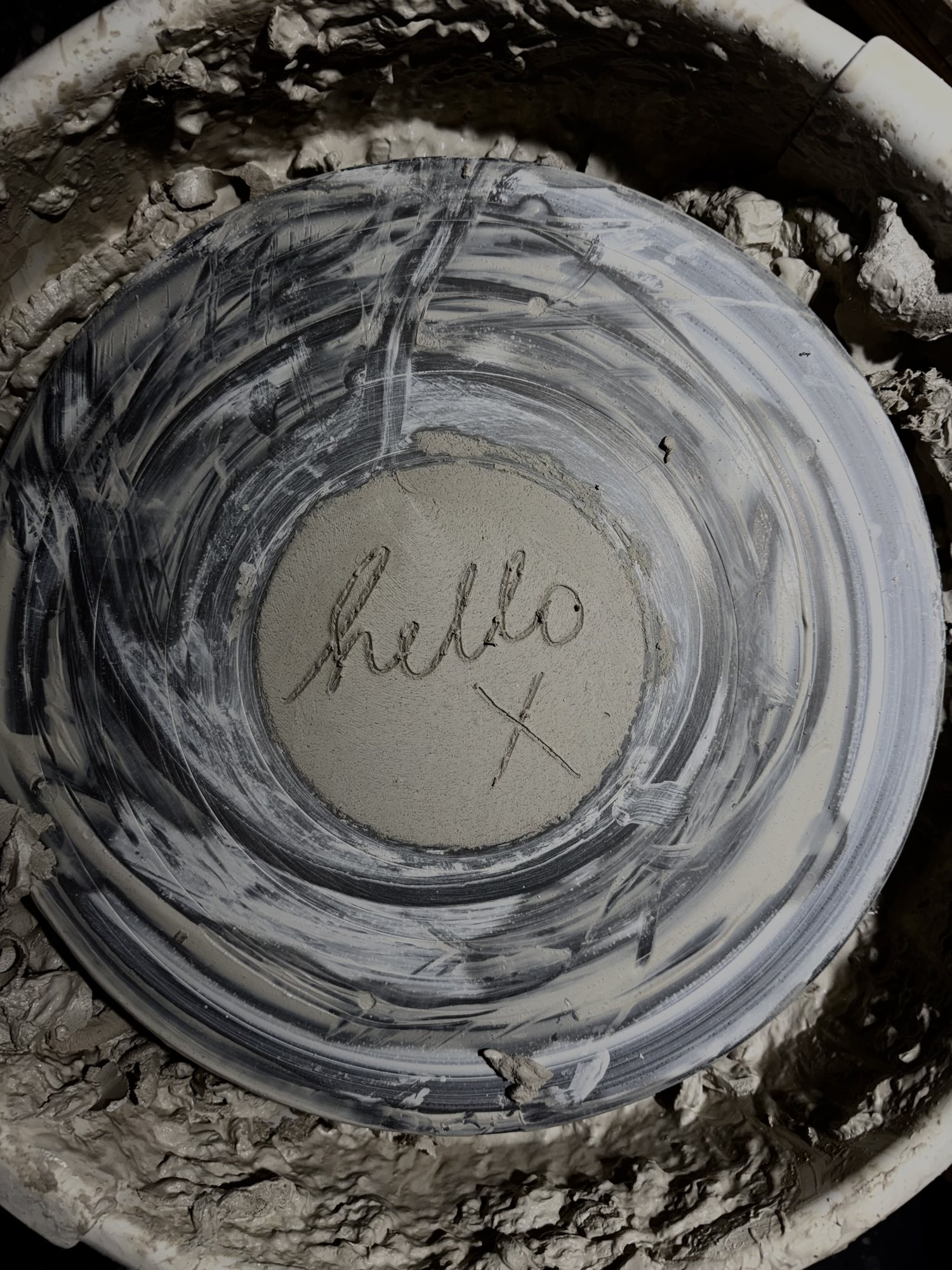 Hello, scratched into wet clay on the wheel