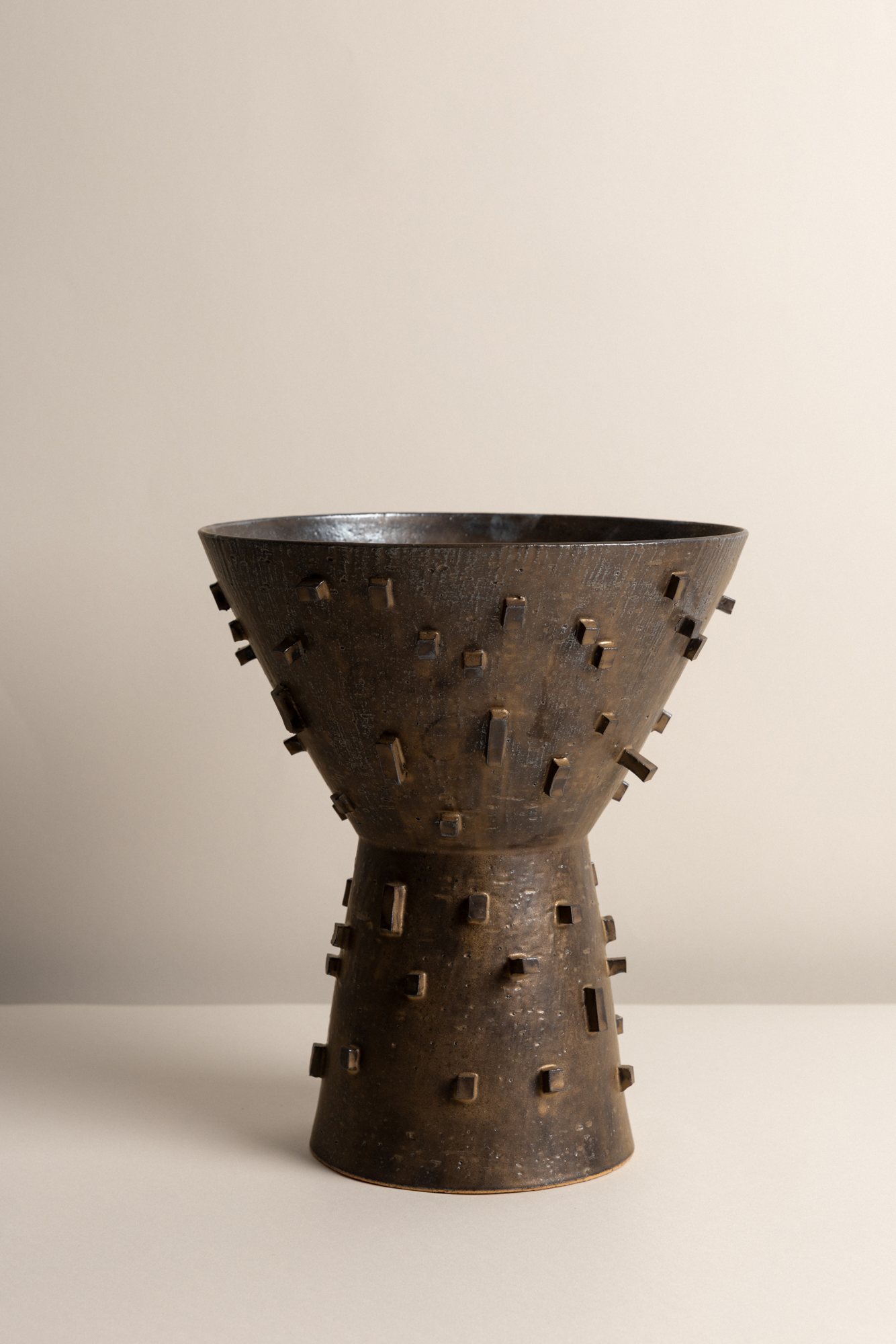 A dark footed vessel studded with small tabs