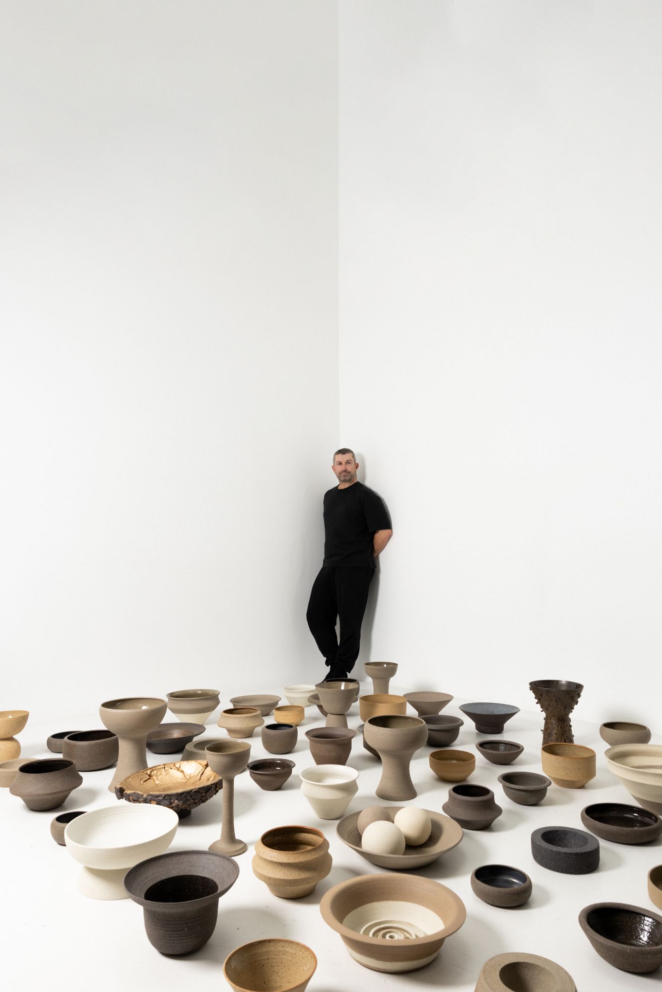 Craig Spencer standing among his pieces