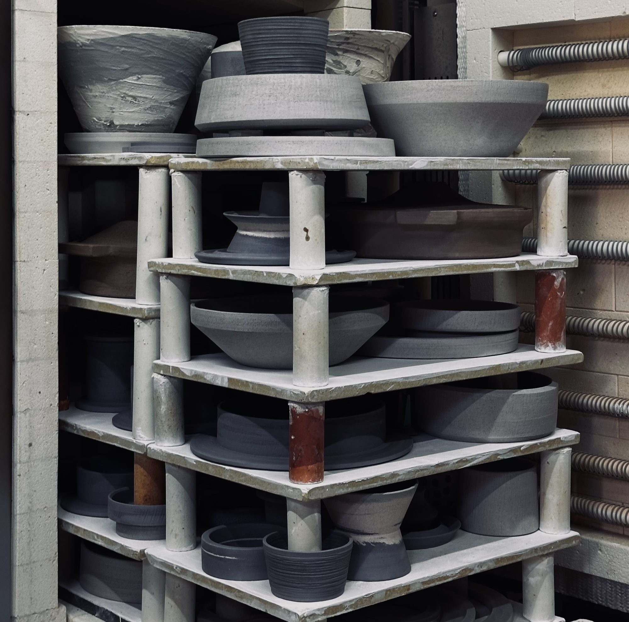 Freshly thrown bowls drying on the studio shelves