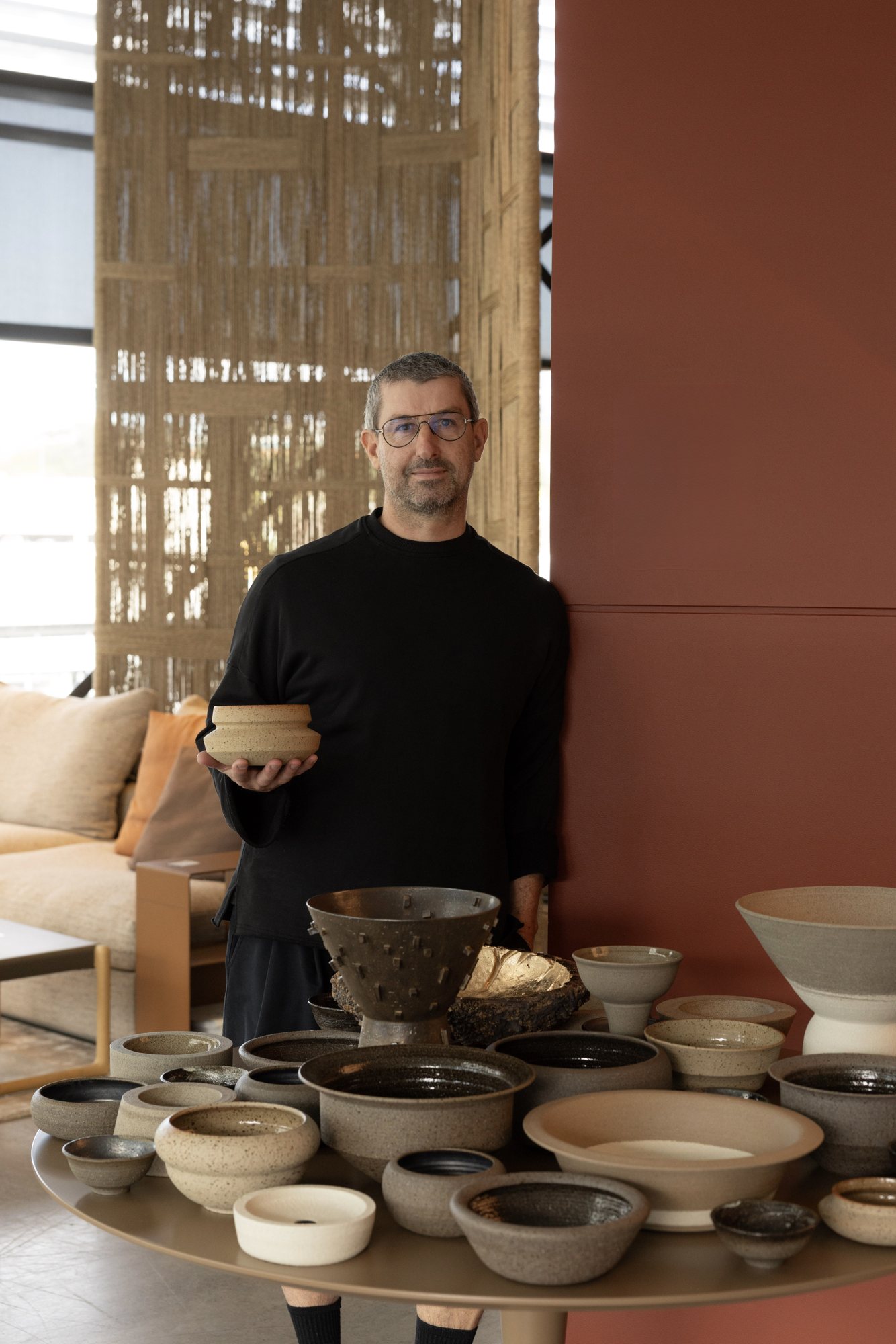 Craig Spencer at a table set with his bowls and vessels